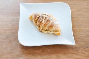 The croissant is placed on a plate ready to eat. photo