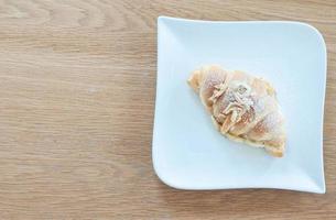 The croissant is placed on a plate ready to eat. photo