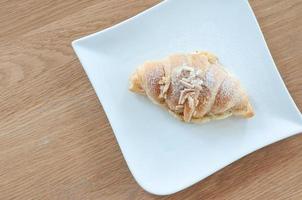 The croissant is placed on a plate ready to eat. photo