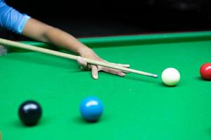 An Asian woman playing snooker. photo