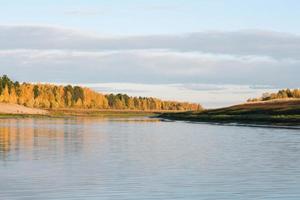 siberian taiga river flowing, autumn bank of the river.fall forest yellow colors photo