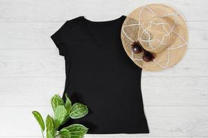 T shirt black. T-shirt Mockup flat lay with summer accessories. Hat and sunglasses on wooden floor background. Copy space. Template blank canvas. Front top view. photo