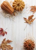 Autumn background of leaves and pumpkins photo