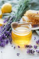 Jar with honey and fresh lavender flowers photo