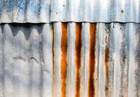 Rusty corrugated galvanized sheet iron fence photo