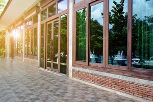 Side view of balcony window of the house made of bricks, wood and large glasses, soft and selective focus. photo