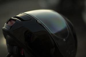 Black motorcyclist helmet. Biker head protection. Safety on road. photo