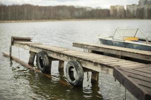 Mooring on lake. Bridge on pond. photo