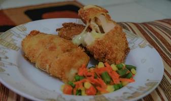 This is home cooking, Chicken Cordon bleu or schnitzel cordon bleu is a dish of chicken meat wrapped in cheese, then breaded and fried. photo