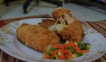 This is home cooking, Chicken Cordon bleu or schnitzel cordon bleu is a dish of chicken meat wrapped in cheese, then breaded and fried. photo