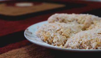 Chicken coated with breadcrumbs is ready to be fried,. photo