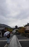 Kyoto, Japan on April 8, 2019. People are walking while using umbrellas because it is raining. photo