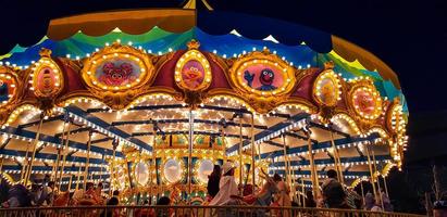 Osaka, Japan on April 9, 2019. Happy people ride the merry-go-round at Universal Studio Japan photo