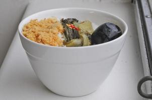Homemade shredded pork floss and Chinese preserved cabbage and black egg on boiled rice photo