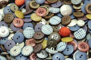 Multi-colored sewing buttons of different sizes and shapes background photo