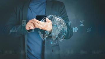 Businessman holding and using mobile phone or smartphone. Concept of Business global internet connection application technology and digital marketing, Teamwork, Leadership, Financial, big data. photo