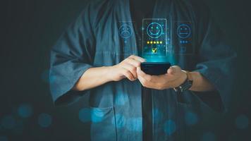 Man using a smartphone in give rating to service experience on application. Online customer review satisfaction feedback survey. photo