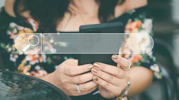 The concept of using technology to search for information, a man's hand is using a smartphone to search for information on social media via the Internet online. photo