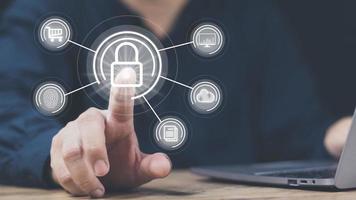 cyber security concept man's hand using a smartphone to the system through the fingerprint scanner Store data into online Cloud Data storag for security. photo