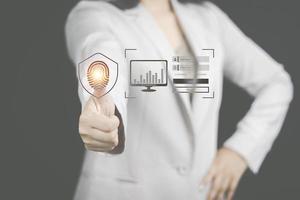 cyber security concept woman's hand using a smartphone to the system through the fingerprint scanner Store data into online Cloud Data storag for security. photo