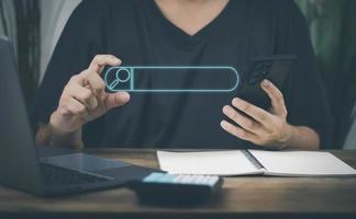 The concept of using technology to search for information, a man's hand is using a smartphone to search for information on social media via the Internet online. photo