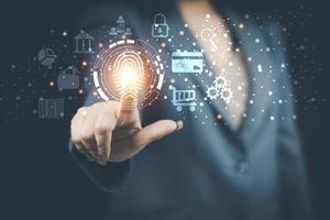 cyber security concept woman's hand using a smartphone to the system through the fingerprint scanner Store data into online Cloud Data storag for security. photo