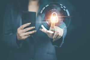 cyber security concept, woman's hand using a smartphone Log in to applications via fingerprint scanning. It is the security of the information. photo