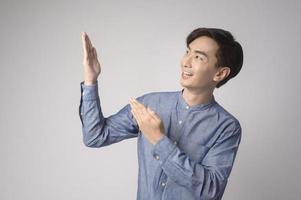 Portrait of young asian man over white background studio. photo