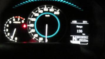 car dashboard at night in blurred background photo