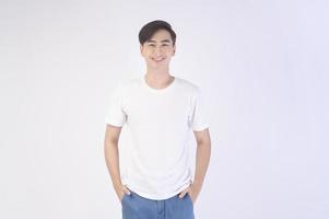 Portrait of young asian man over white background studio. photo