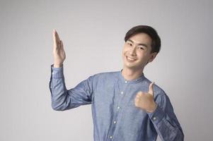 Portrait of young asian man over white background studio. photo