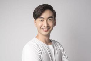 Portrait of young asian man over white background studio. photo