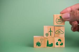 wood cube block icon net zero carbon credit and eco energy green technology on green background. photo