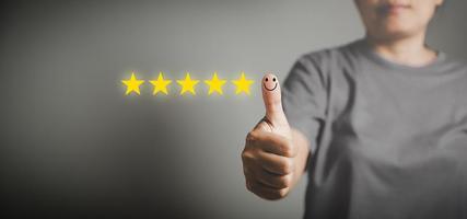 Hand with thumb up positive emotion smiley face icon and 5 star with copy space. Emotional smiley faces showing excellent satisfaction. rating very impressed. Customer service and satisfaction concept photo