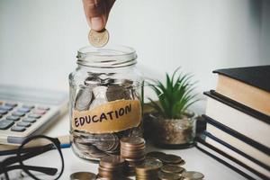 close-up education object with stack money coin-cash dollar and glass jar on background. Concept to saving money income for study, Calculating student finance costs and investment budget loan photo