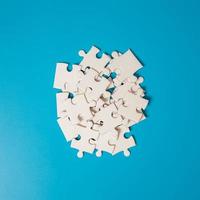 White part of jigsaw puzzle pieces on blue background. concepts of problem solving, business success, teamwork, Team playing jigsaw game incomplete, Texture photo with copy space for text