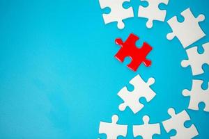 White part of jigsaw puzzle pieces on blue background. concepts of problem solving, business success, teamwork, Team playing jigsaw game incomplete, Texture photo with copy space for text