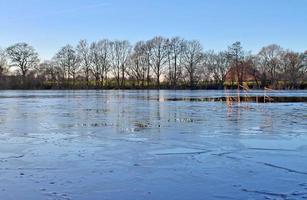 Beautiful winter shot at a lake and forest with snow and ice. photo