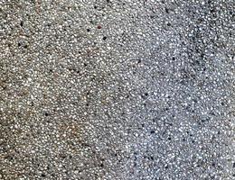 Detailed close up view on pebbles and stones on a gravel ground texture photo