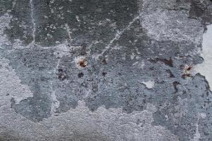 Detailed close up view on aged concrete walls with cracks and lots of structure photo