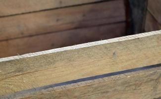 Very old wooden crates with some cracks in a close up view photo