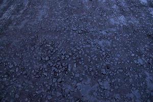 fondo de textura de piedra de carretera de mosaico de betún crudo negro foto