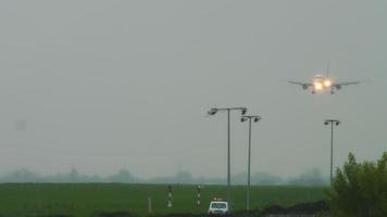 Jet airplane approaching before landing on runway at rainy weather. Airport of Almaty, Kazakhstan video