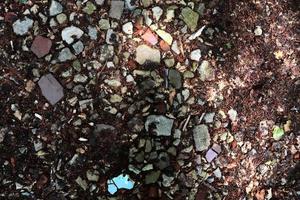 Detailed close up view on pebbles and stones on a gravel ground texture photo