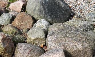 Detailed close up view on pebbles and stones on a gravel ground texture photo