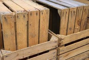 Very old wooden crates with some cracks in a close up view photo