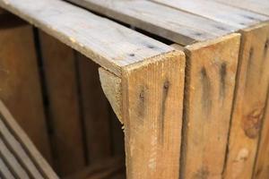 Very old wooden crates with some cracks in a close up view photo