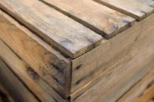 Very old wooden crates with some cracks in a close up view photo