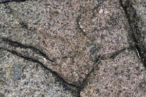 Detailed close up view on aged concrete walls with cracks and lots of structure photo