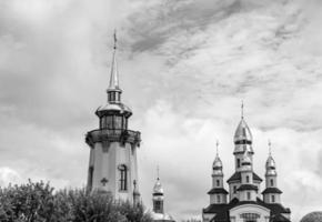 Christian church cross in high steeple tower for prayer photo